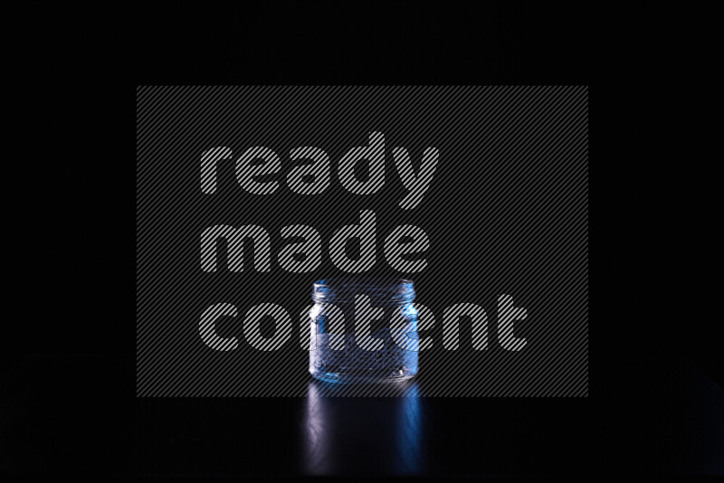 Glassware with rim light in blue and white against black background