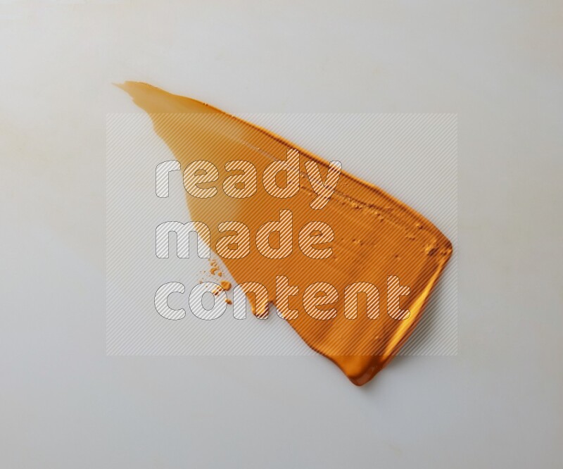 An orange straight painting knife stroke on white background