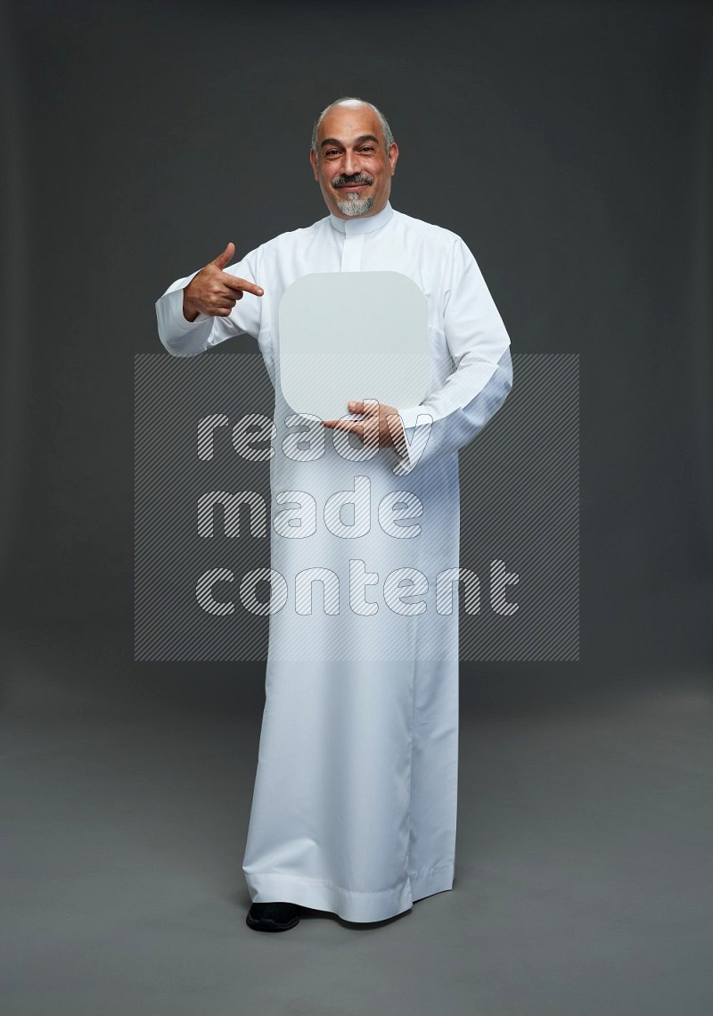 Saudi man without shomag Standing holding social media sing on gray background