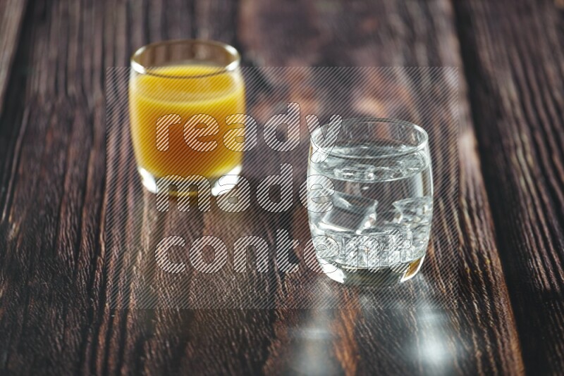 Cold drinks in a glass cup such as water, tamarind, qamar eldin, sobia, milk and hibiscus on wooden background
