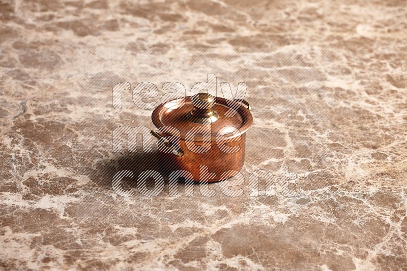 Small Copper Pot on Beige Marble Flooring, 45 degrees