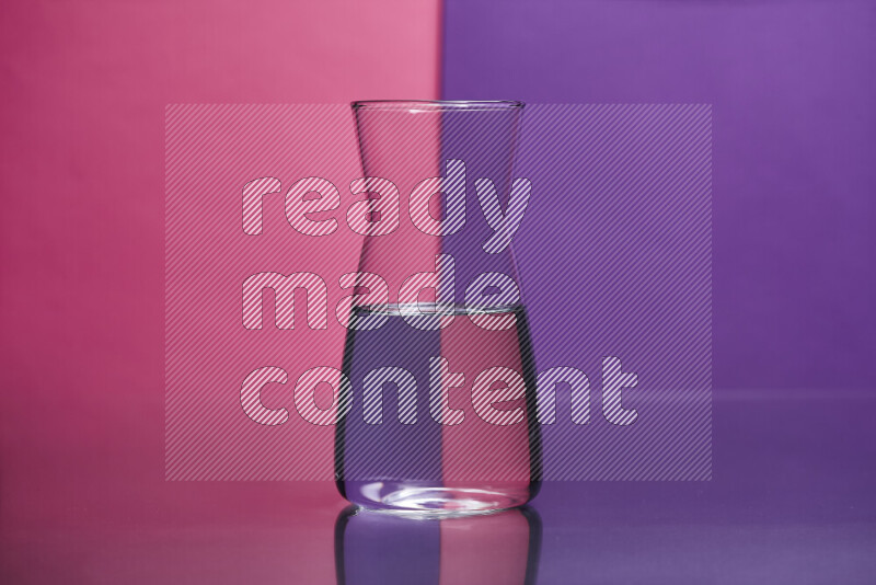 The image features a clear glassware filled with water set against pink and purple background