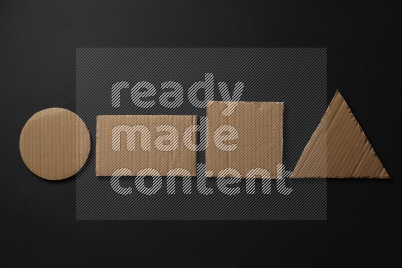 Cardboard in shapes on black background