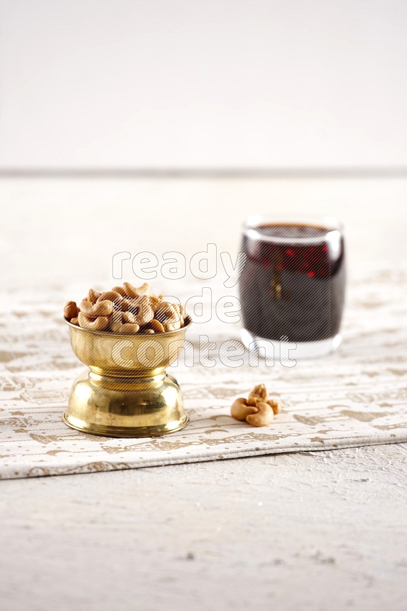 Nuts in a metal bowl with tamarind in a light setup