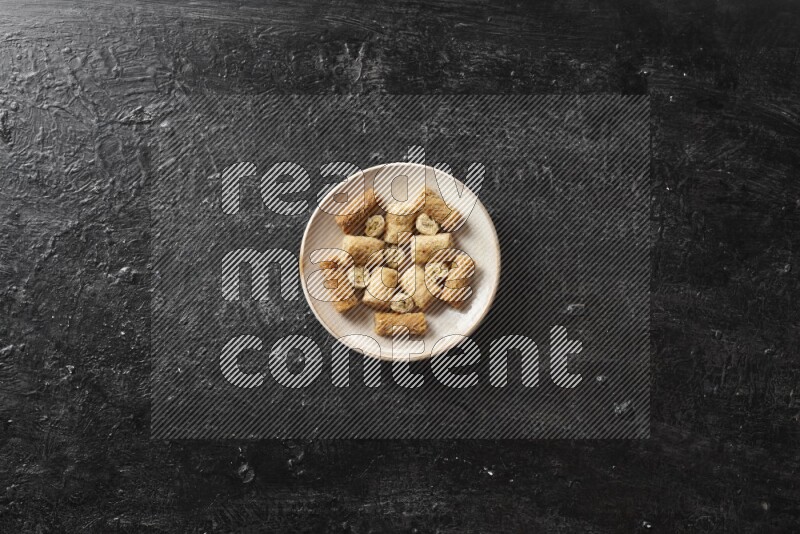 Oriental sweets in pottery plates in a dark setup