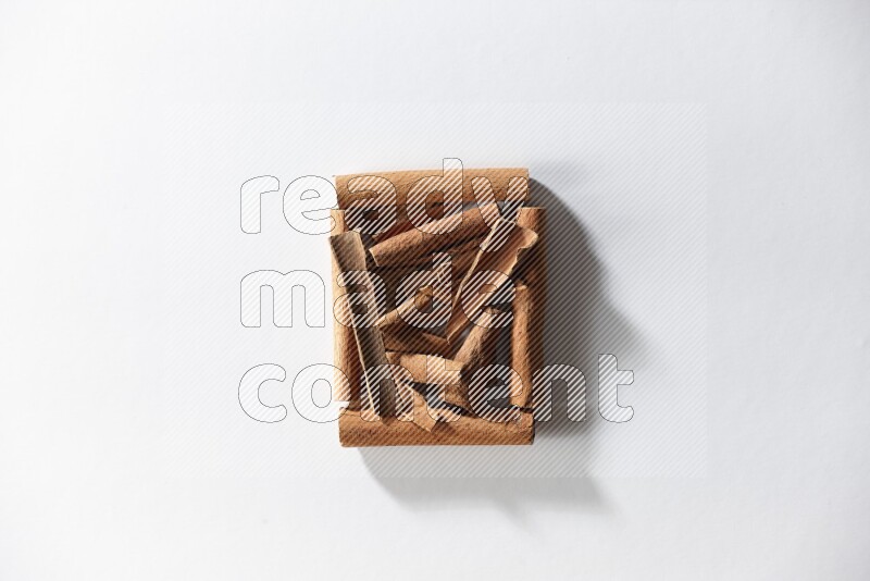 A single square of cinnamon sticks full of cinnamon on white flooring