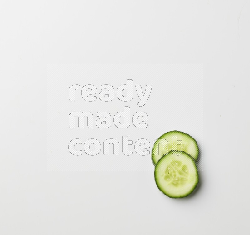 two cucumber slices on white background
