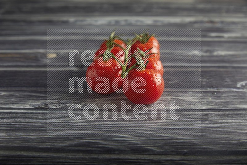 Red cherry tomato vein on a textured grey wooden background 45 degree