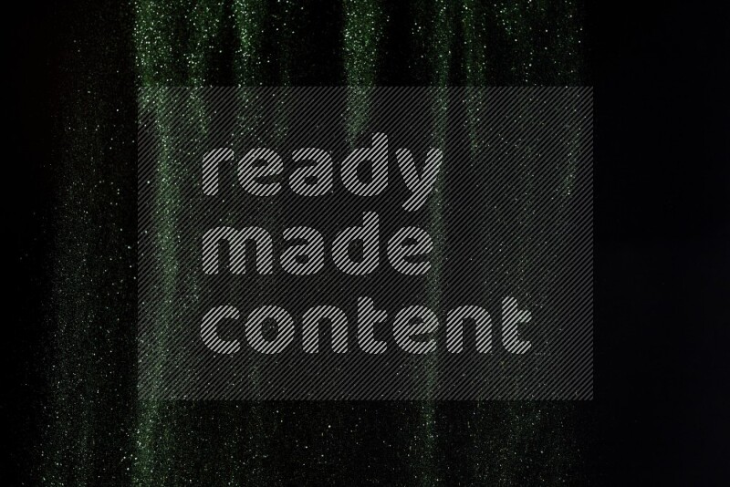 Green glitter powder isolated on black background