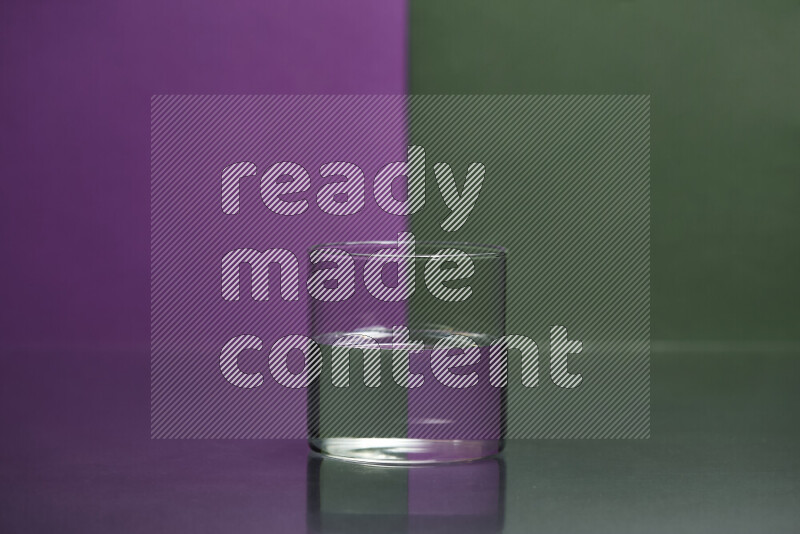 The image features a clear glassware filled with water, set against purple and dark green background