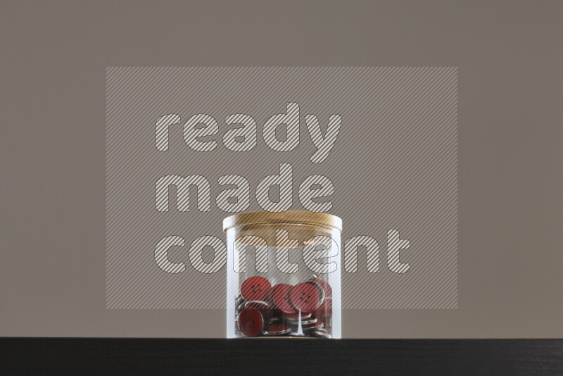 Buttons in a glass jar on black background