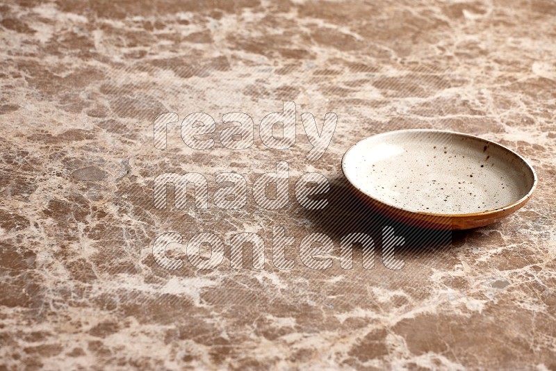 Multicolored Pottery Plate on Beige Marble Flooring, 45 degrees