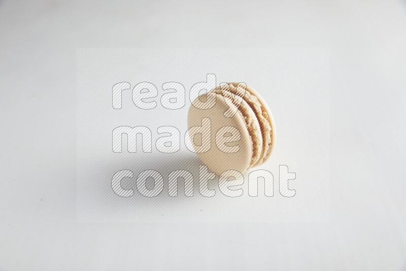 45º Shot of White Caramel fleur de sel macaron on white background