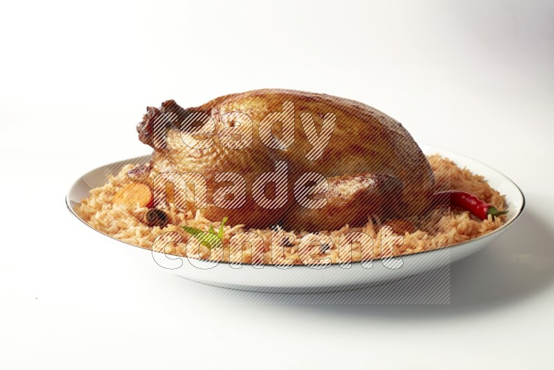 red basmati Rice with whole roasted chicken on a white plate with a silver rim direct on white background