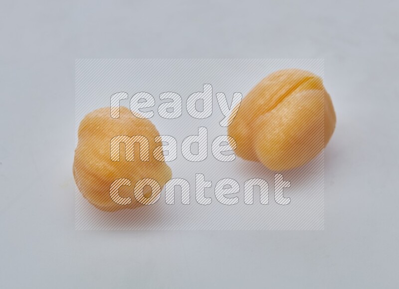 Close up of a boiled chickpeas in a container on white background