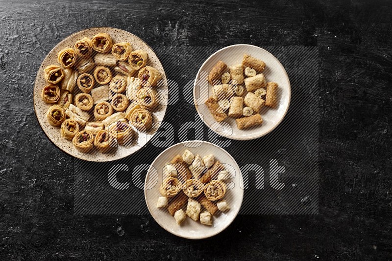 Oriental sweets in pottery plates in a dark setup