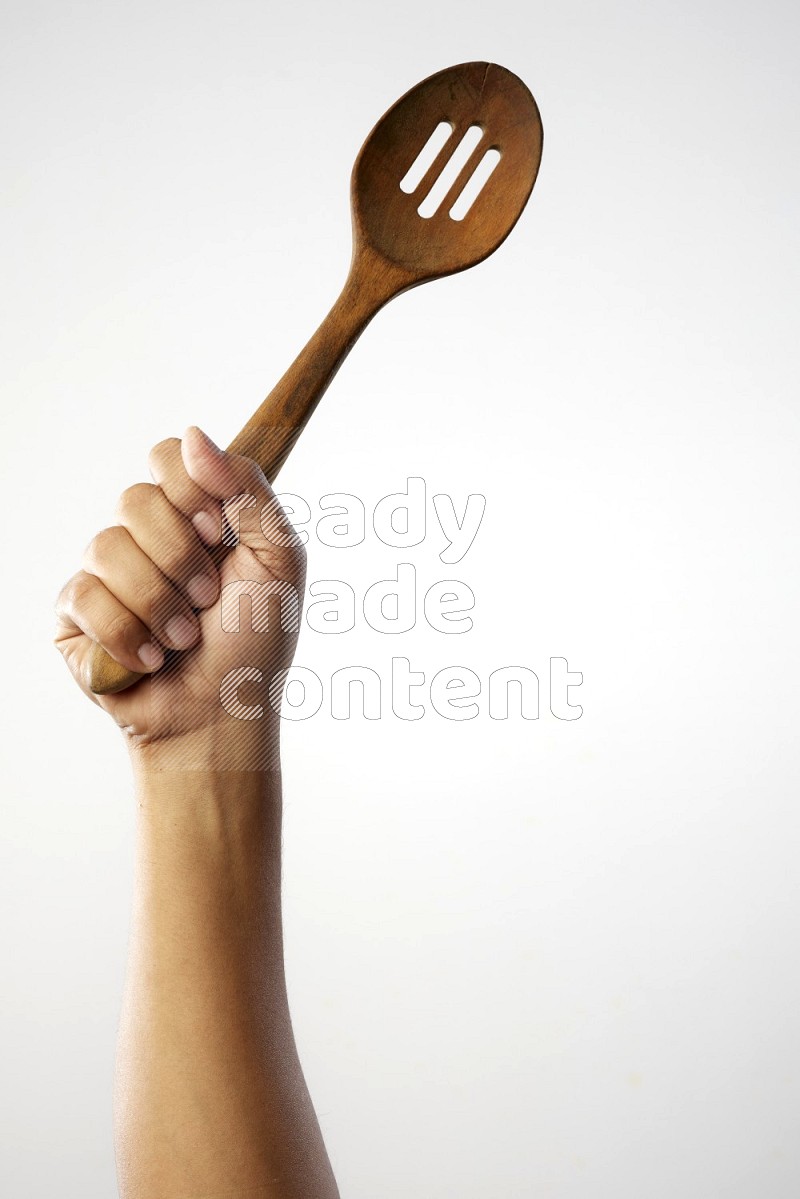 Male Hand Holding Wooden colander spoon  on white background