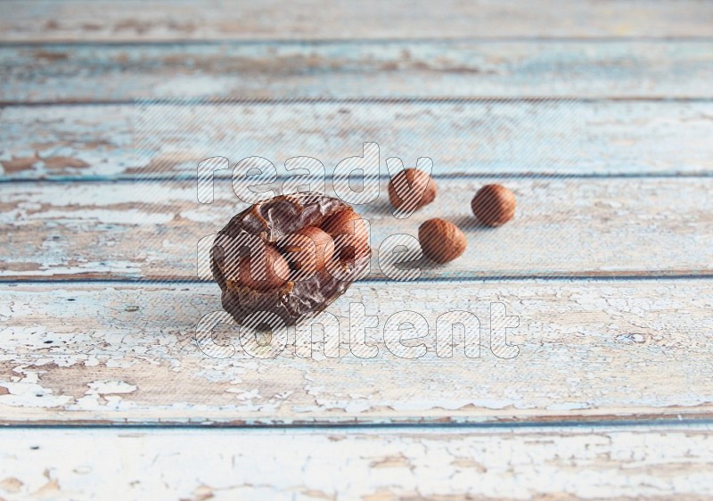 hazelnuts stuffed madjoul date on a light blue wooden background
