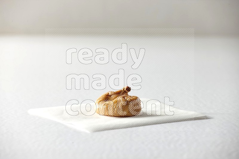 A dried fig on a piece of paper on a white background in different angles