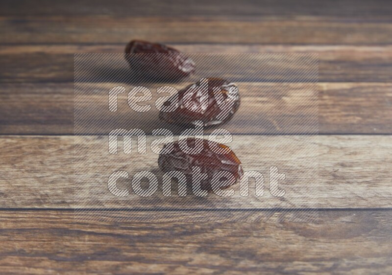three madjoul dates on a wooden background
