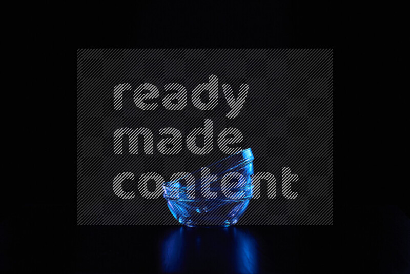 Glassware with rim light in blue against black background