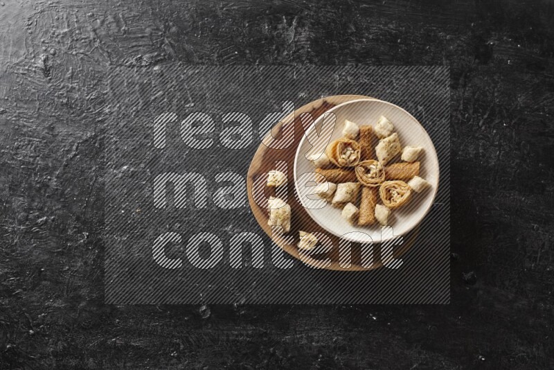 Oriental sweets in pottery plates in a dark setup