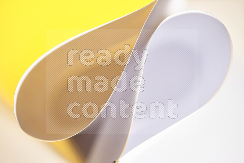 An abstract art of paper folded into smooth curves in white and yellow gradients