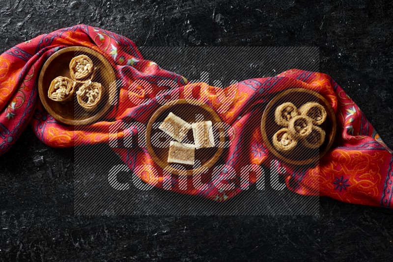 Oriental sweets in wooden bowls in a dark setup