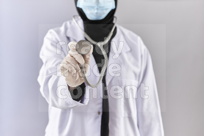 Female doctor wearing an abaya and medical attire in different positions