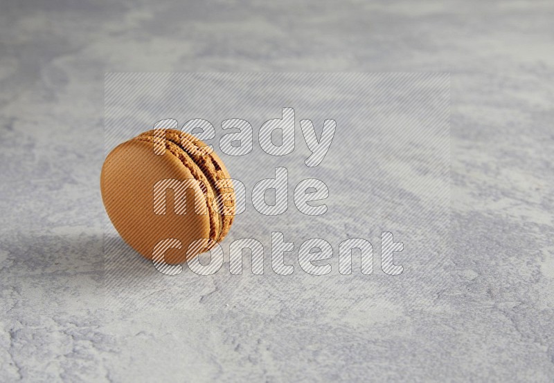 45º Shot of Brown Maple Taffy macaron on white  marble background