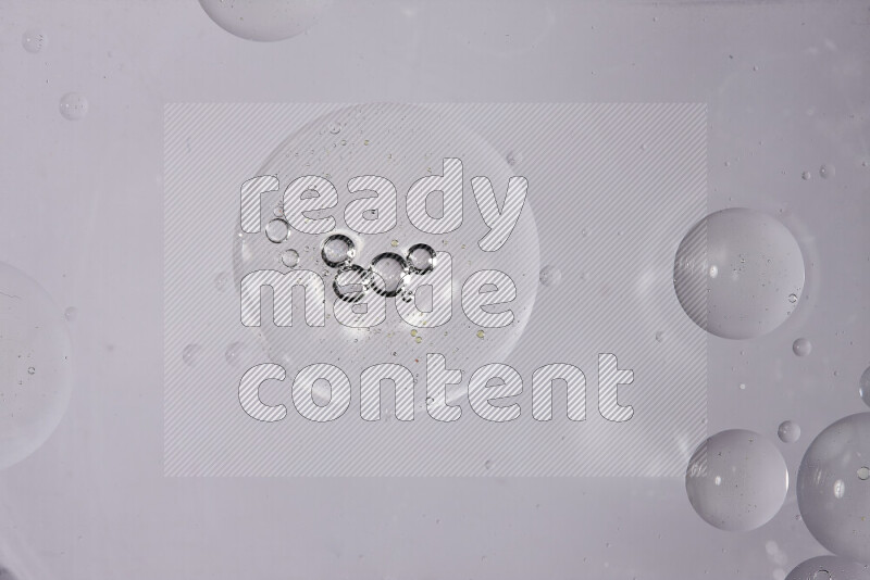 Abstract oil droplets in a water surface on white background