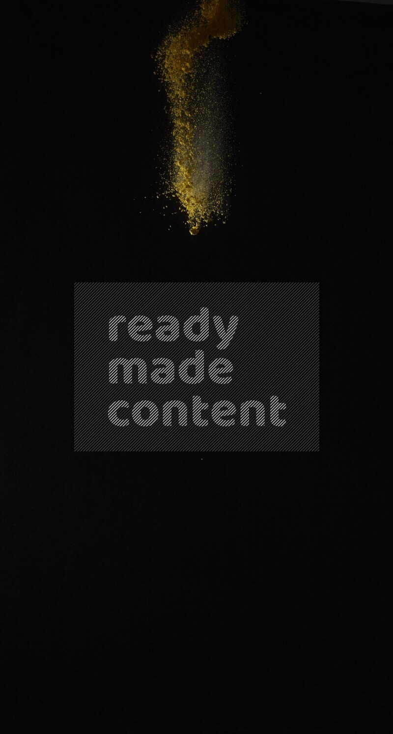 A side view of yellow powder explosion on black background