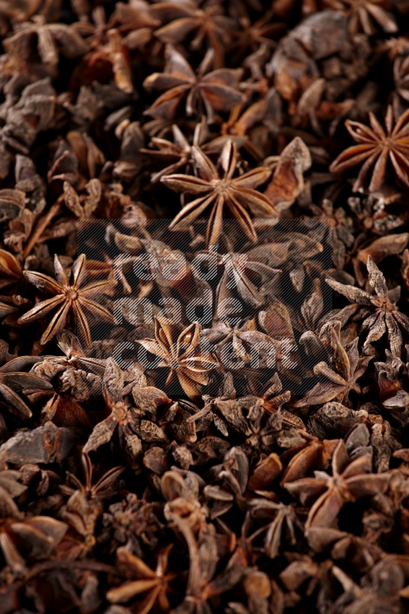 Star Anise herbs fill the frame on black flooring
