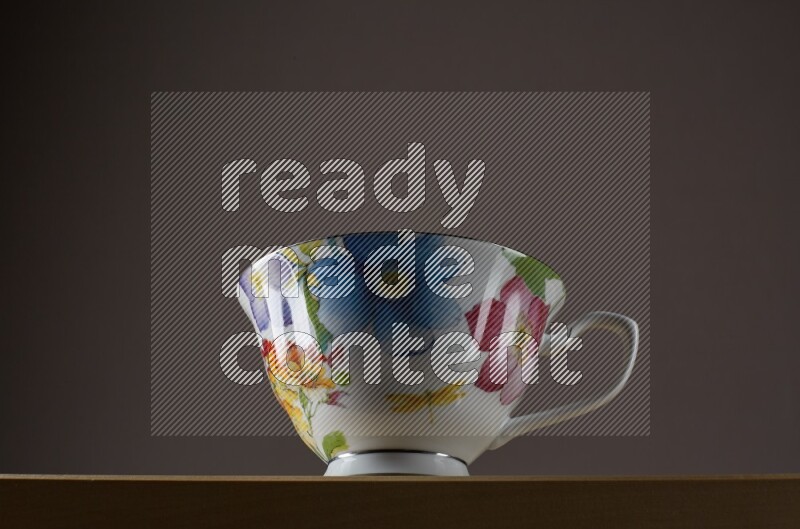 Low angle shot of a decorated cup on grey background