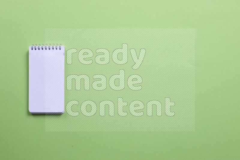 A blank open notebook on green background