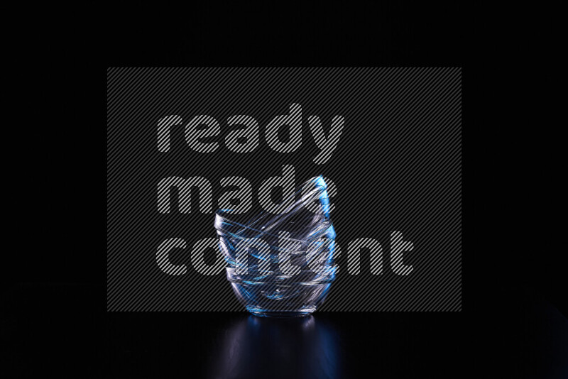 Glassware with rim light in blue and white against black background