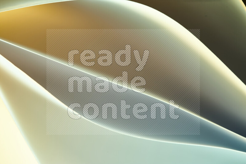 This image showcases an abstract paper art composition with paper curves in green and yellow gradients created by colored light