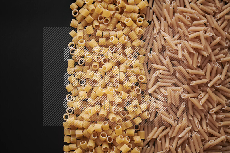 Different pasta types on black background