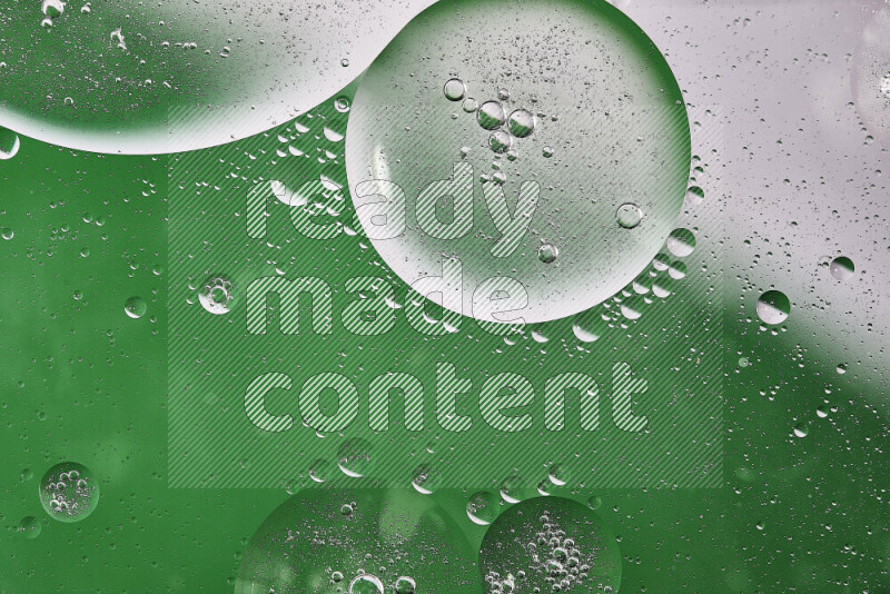 Close-ups of abstract oil bubbles on water surface in shades of white and green