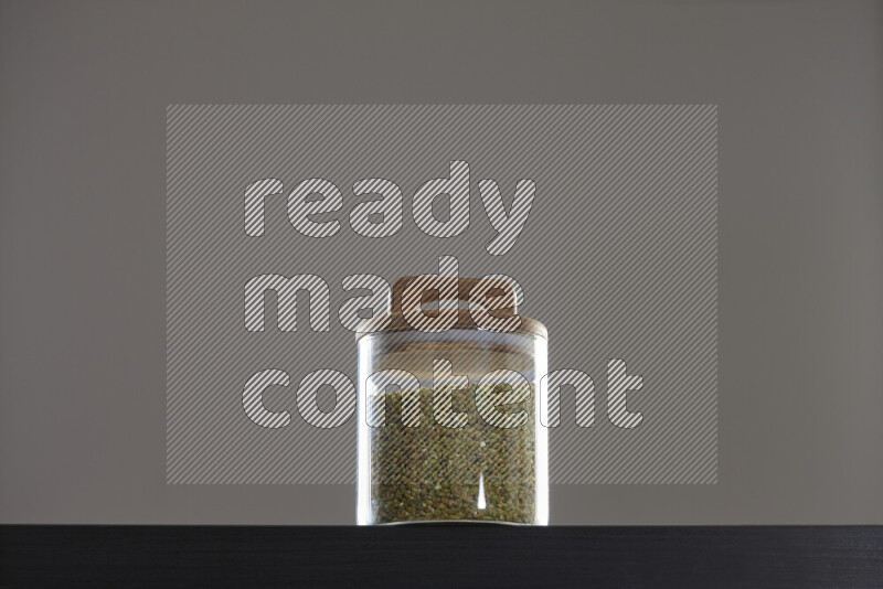 Freekeh in a glass jar on black background