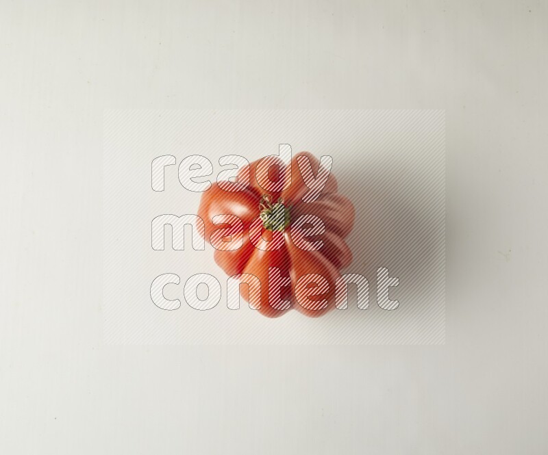 Single topview Heirloom tomato on a white backgrounds