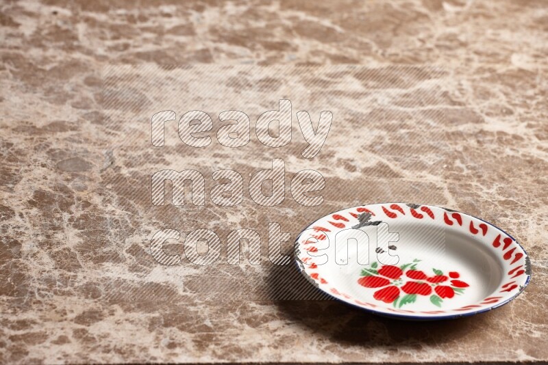 A vintage metal plate on beige marble background