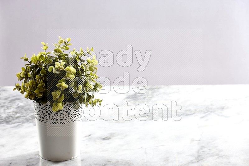 Artificial Plant in White Decorative Pot on Light Grey Marble Background 45 degree angle