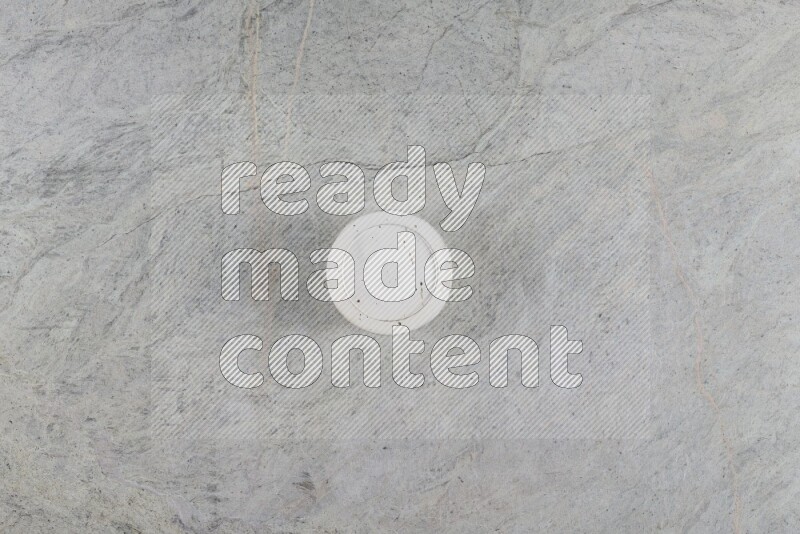 A multicolored pottery Cup on grey marble background