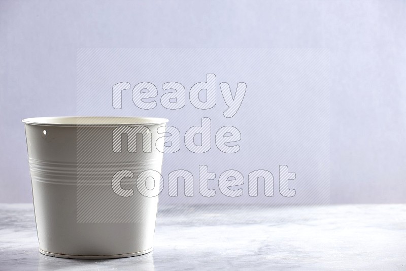 An Empty White Plant Pot on light grey Marble Flooring 15 degree angle