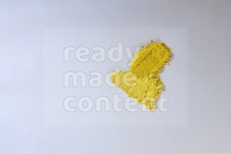Yellow powder strokes on white background