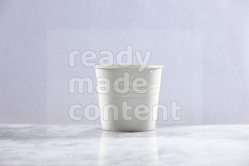 An empty white plant pot on grey marble background