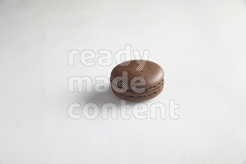 45º Shot of Brown Dark Chocolate macaron on white background