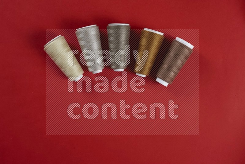 Brown sewing supplies on red background