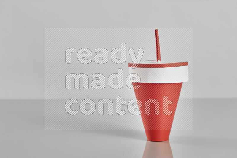 Origami cup on grey background